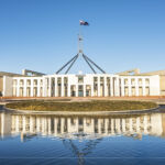The national flag flutters on the Parliament House, Canberra, Australia.