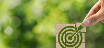Environmental goals of green business Business development strategy with sustainable environmental conservation wooden block on handle With a green target icon. copy space