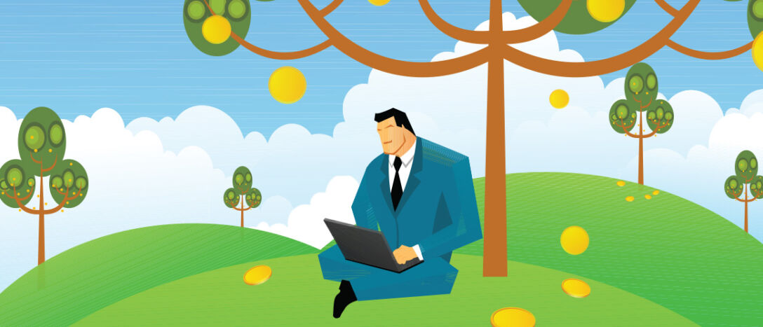 businessman with laptop under a tree