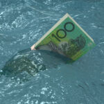 Australian money falling finance crisis sinking sea water
