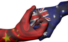 Diplomatic handshake between countries: flags of China and Australia overprinted the two hands