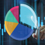 Image of a person pointing at a pie chart.